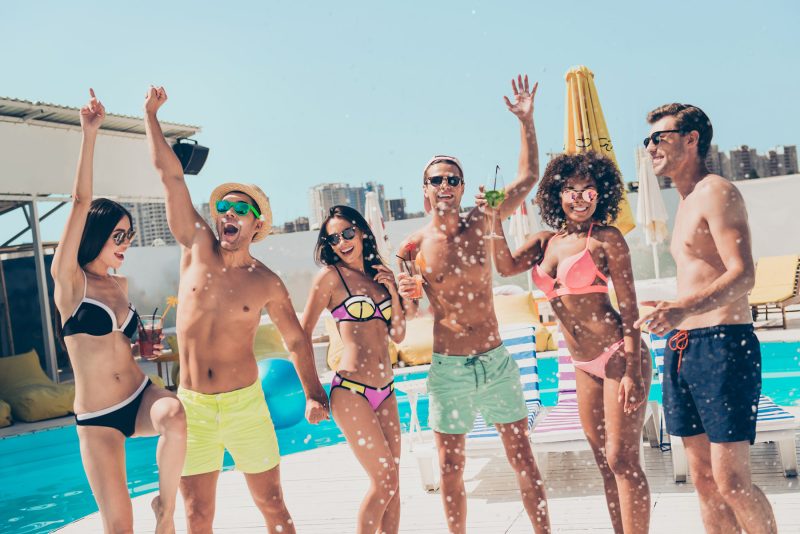 Men and women having fun poolside